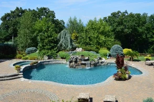 Residential pool edge with equipment pad visible